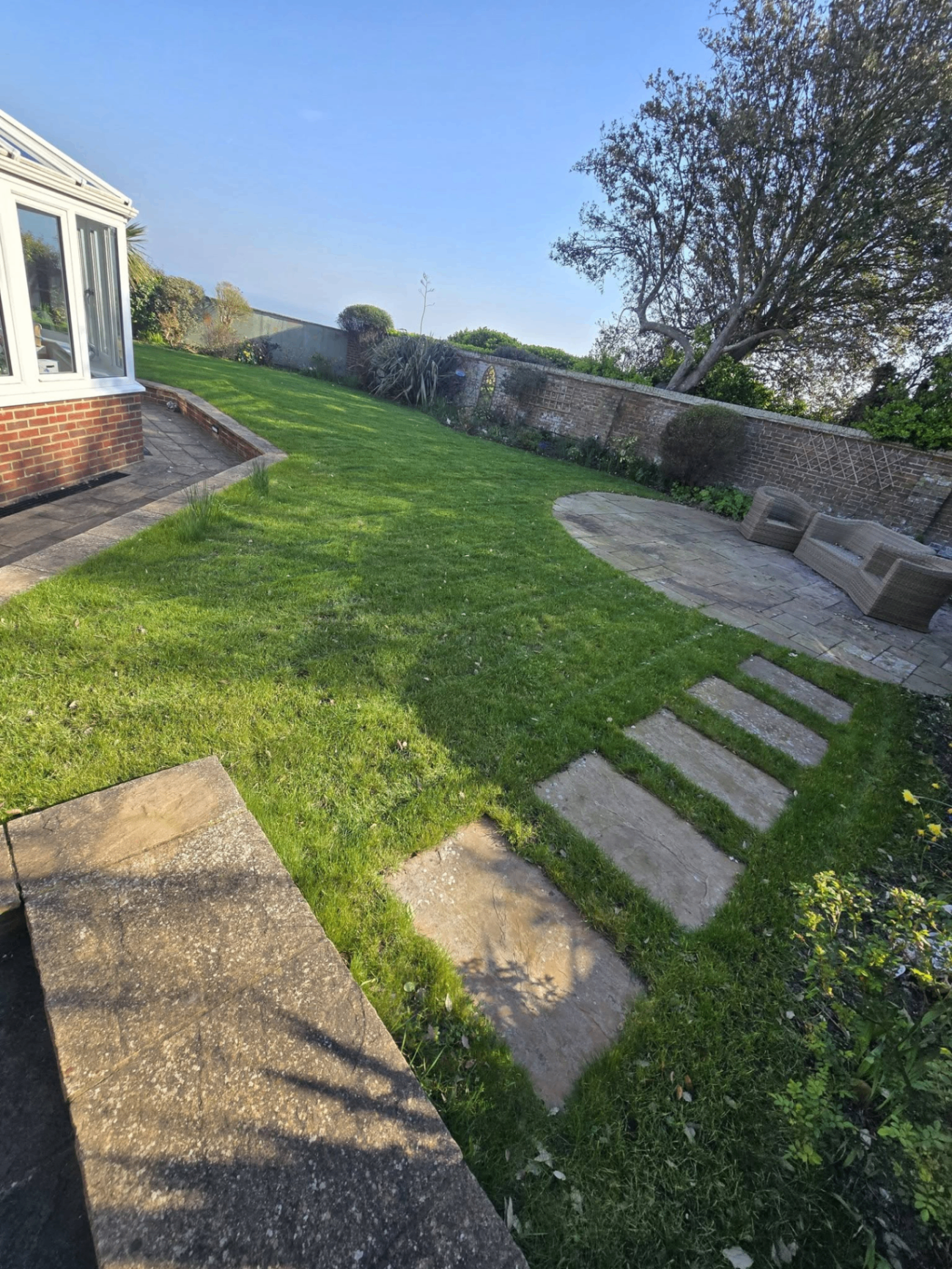 Maintained garden with lawn, stepping stones and patio