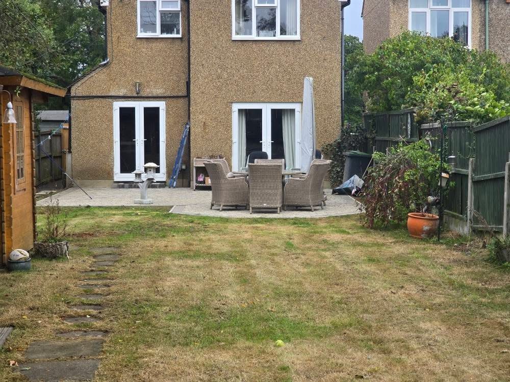 Back garden lawn cut and tidied around patio and stepping stones